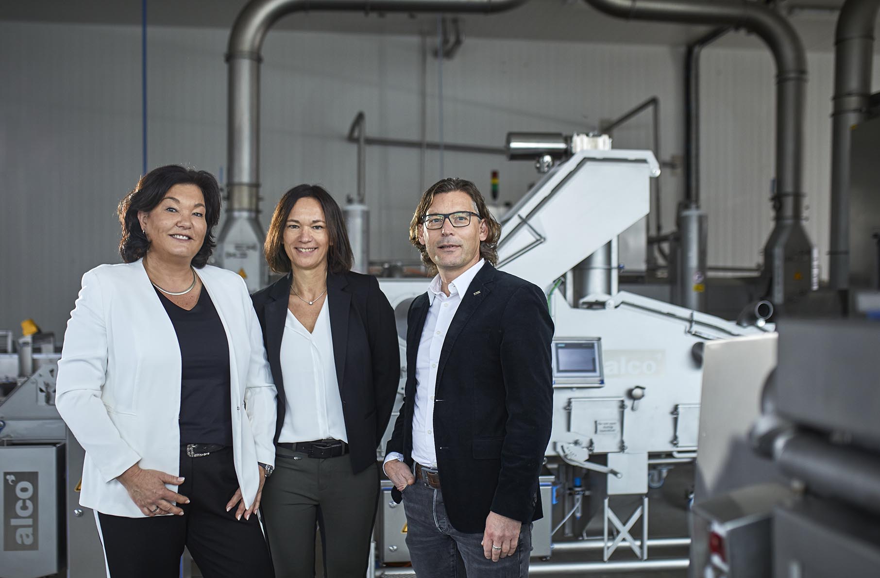 family members in front of a machine