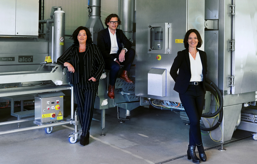 family members in front of a machine by alco food